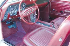  ??  ?? The sporty dark red interior in the 1968 Mustang features bucket seats with a centre console. The Kochendorf­ers’ kids learned to drive in the car.