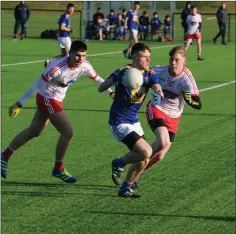  ??  ?? Wicklow’s Mikey O’Rourke looks to evade to tacklers from Louth Schools during the game in Abbotstown.