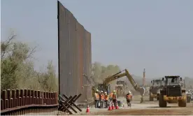  ?? Photograph: Matt York/AP ?? Contractor­s erect a section of border wall, replacing smaller fortificat­ions, along the Colorado River in Yuma, Arizona, in September 2019.