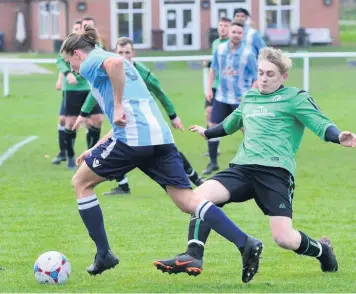  ??  ?? Cheadle Town’s Sam Roden, right, moves in to challenge Silverdale Athletic’s Alex Djukic during the PDSL Division One match at the weekend.