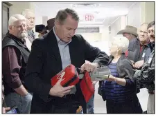  ?? Arkansas Democrat-Gazette/FRANCISCA JONES ?? Church security seminar attendees look on Monday as North Little Rock Police Chief Mike Davis opens a defibrilla­tor during a walk-through security check of Park Hill Baptist Church in Little Rock on Monday.