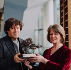  ??  ?? Pádraigín Ni hUllacháin is presented with her award by Stephen Rea.