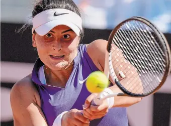  ?? ANDREW MEDICHINI THE ASSOCIATED PRESS ?? Bianca Andreescu of Canada returns the ball to Iga Swiatek of Poland during their match at the Italian Open tennis tournament in Rome on Friday. Swiatek won, 7-6 (2), 6-0.