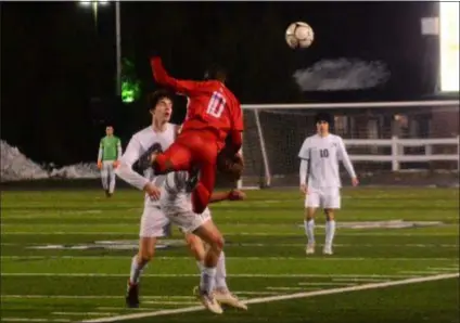  ?? BILL RUDICK – FOR DIGITAL FIRST MEDIA ?? Wilson’s Patrick Ndambo heads a ball while almost taking off the head of Radnor’s Bobby Hydrisko Saturday. Radnor’s Eliot Hayes is right on top of the play while Ben Verbofsky, right, looks on from a distance.