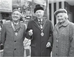  ??  ?? The Mayor, Cllr Dick Shaw (centre) flicked the switch to turn on Maidenhead’s Christmas lights in 1985. Ref:133202-8