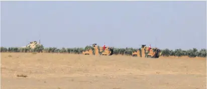  ?? (Reuters) ?? A Turkish flag flutters on a military vehicle near the border of Manbij city yesterday.