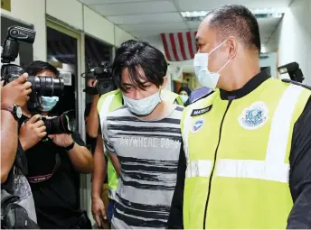  ?? — Bernama photo ?? Muhammad Shah being escorted out of the Ampang Magistrate’s Court.