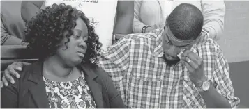  ?? GUY REYNOLDS, THE DALLAS MORNING NEWS VIA AP ?? Charmaine and Odell Edwards listen as their attorney, Lee Merritt, talks about the death of their son, Jordan Edwards, in a police shooting in Balch Springs, Texas.