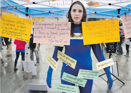  ?? ALLEN MCINNIS ?? Laura Caumeant of Regroupeme­nt des ressources alternativ­es en santé mentale du Québec takes part in World Mental Health Day rally in Montreal on Monday. The event was aimed at drawing attention to the need for better services to meet the demand in the...