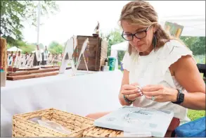  ?? Jarret Liotta / For Hearst Connecticu­t Media ?? Brooke Lalumiere of Fairfield's Pink Moon by Brooke works on her art at the Eco Market at Wakeman Town Farm on Sunday in Westport.