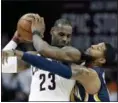  ?? TONY DEJAK — THE ASSOCIATED PRESS ?? The Pacers’ Paul George reaches in against LeBron James in the second half in Game 2 on April 17 in Cleveland.