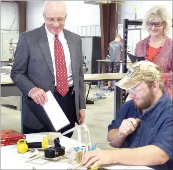  ?? TIMES photograph by Annette Beard ?? During a tour of Pea Ridge Manufactur­ing and Business Academy, Phillip Young, director of Arch Ford Coop, and Lenette Thrasher, teacher center coordinato­r of Arch Ford, watched while Sheldon Colf, second year associate in Industrial Technology,...