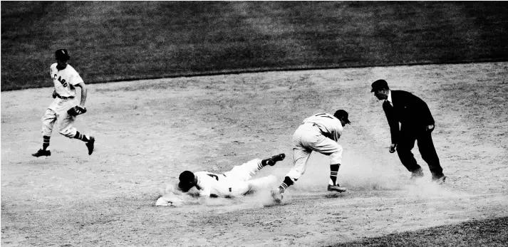  ?? AP FILE PHOTO ?? The Cardinals’ Enos Slaughter slides past a tag attempt by the White Sox’s Chico Carrasquel, right, during the 1953 All-Star Game at Crosley Field in Cincinnati.