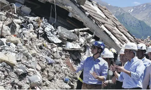  ?? EMILIANO GRILLOTTI / AFP / GETTY IMAGES ?? Prime Minister Justin Trudeau listens to Italy’s Foreign Affairs Minister Angelino Alfano during a visit to Amatrice, Italy, a medieval town that was destroyed in an earthquake last August.