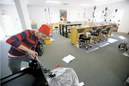  ?? PHOTOS BY LUIS SÁNCHEZ SATURNO/THE NEW MEXICAN ?? Lauren Tobey, owner of Meltdown Studio, sets up one of her toolboxes last week at her Santa Fe studio in preparatio­n for opening her second location. Tobey’s first location is in Albuquerqu­e. Meltdown Studio features space and tools — such as polishing...