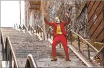  ?? Niko Tavernise Warner Bros. Pictures ?? JOAQUIN PHOENIX as Arthur Fleck dances down the Bronx step street that has come to be called the “Joker Stairs.”