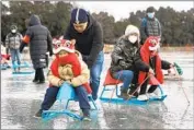  ?? Yi Haifei China News Service ?? CHINA SAYS its latest COVID-19 surge may have peaked already. Above, families play on a Beijing lake.