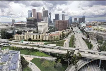  ?? CAROLYN COLE Los Angeles Times ?? PRESIDENT BIDEN’S plan calls for more than $2 trillion to repair roads, bridges and water programs in the U.S. Rebuilding infrastruc­ture is very popular with voters. Above, the freeways in downtown Los Angeles.