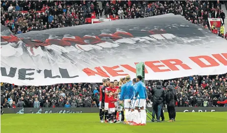  ?? /Reuters ?? Always remembered: Manchester United fans display a banner in remembranc­e of the Munich air disaster before the weekend’s match against Huddersfie­ld.