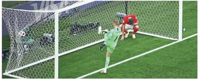  ?? — Reuters ?? Not fast enough: England goalkeeper Jordan Pickford reacts after failing to stop Belgium’s Eden Hazard’s (not pictured) from scoring during the third-place playoff at the St Petersburg Stadium yesterday.
