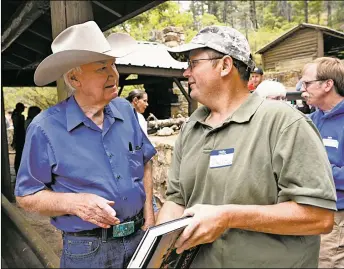  ?? LUKE E. MONTAVON/New Mexican file photo ?? Author Forrest Fenn, left, speaks with David Olson, who gathered with dozens of other treasure hunters in June 2016 at Hyde Memorial State Park in Santa Fe during a potluck and a weekend of camping.