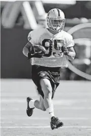  ?? [AP PHOTO] ?? In this July 26, 2013, file photo, Sam McGuffie carries the ball during the Oakland Raiders training camp in Napa, Calif. After brief stints with numerous teams in the NFL, McGuffie became a bobsleddin­g phenom and will compete for a medal in four-man...