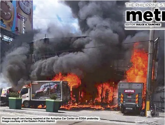  ??  ?? Flames engulf cars being repaired at the Autoplus Car Center on EDSA yesterday. Image courtesy of the Eastern Police District.