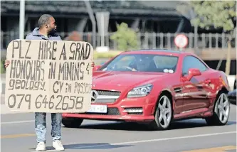  ?? | Reuters ?? A MAN holds a placard with his qualificat­ions as he seeks a job at an intersecti­on in Rosebank, in Joburg. The Covid-19 pandemic and lockdown has seen unemployme­nt climb to 32.5% in the fourth quarter of 2020.