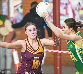  ?? ?? Left: Drouin wing defence Macy Newcombe keeps eyes on the ball as she defends Leongatha’s Jade Cashin in A grade.