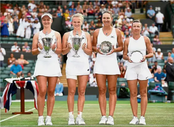  ??  ?? Victors and vanquished: (From left) Czech Republic’s Barbora Krejcikova and Katerina Siniakova celebrate winning the women’s doubles final with the trophies as they pose with runners-up Nicole Melichar of the US and Czech Republic’s Kveta Peschke. —...