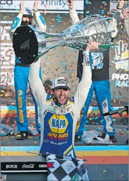  ?? RALPH FRESO/AP PHOTO ?? Chase Elliott holds up the season championsh­ip trophy as he celebrates in Victory Lane after winning the NASCAR Cup race on Sunday in Avondale, Ariz.