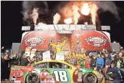  ?? Steve Helber / AP ?? Kyle Busch (center) celebrates in Victory Lane after winning the NASCAR Cup Series race at Richmond Raceway.