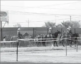  ?? GREGORY BULL / AP FILE (2017) ?? People are detained by Border Patrol agents on horseback after crossing the border illegally from Tijuana, Mexico. More than 1,600 people arrested at the U.s.-mexico border, including parents who have been separated from their children, are being...