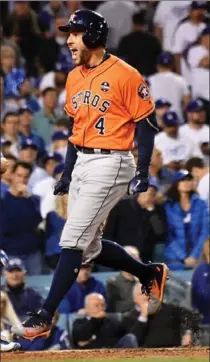  ?? WALLY SKALIJ, LOS ANGELES TIMES ?? George Springer celebrates his two-run home run in front of L.A. Dodgers catcher Austin Barnes in the second inning of Game 7.