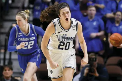  ?? JESSICA HILL — THE ASSOCIATED PRESS ?? Villanova’s Maddy Siegrist, right, celebrates during the first half of the Wildcats’ 63-61victory over Creighton in the Big East semifinals Sunday night. Second-seeded Villanova takes on top-seed UConn Monday night for the title.