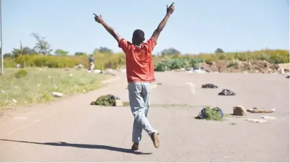  ?? Picture: Tracy Lee Stark ?? Residents of Mooiplaas barricaded the road yesterday, not allowing access into the area . The residents say the protest is related to RDP housing and service delivery grievances.