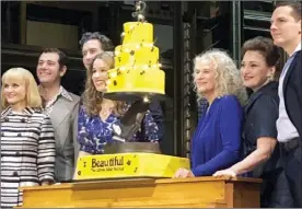  ?? The Associated Press ?? Carole King, third from right, poses for photos Saturday with the cast of “Beautiful: The Carole King Musical” at the Stephen Sondheim Theatre after a performanc­e in New York. King appeared Saturday night, sitting at a baby grand piano and showing all the love in her heart as she sang "Beautiful," the final song to celebrate the show's fifth anniversar­y on Broadway.