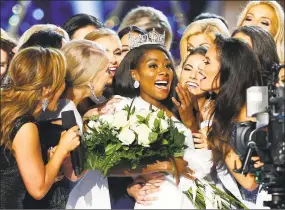  ?? Noah K. Murray / Associated Press ?? This Sept. 9 file photo shows Miss New York Nia Franklin, center, reacting after being named Miss America 2019 in Atlantic City, N.J. The Miss America Organizati­on says this year’s pageant will be held at the Mohegan Sun in Uncasville on Dec. 19.