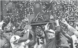  ?? DALE ZANINE/USA TODAY SPORTS ?? Georgia Bulldogs head coach Kirby Smart celebrates with his team after defeating the Auburn Tigers in the SEC championsh­ip game at Mercedes-Benz Stadium in Atlanta.