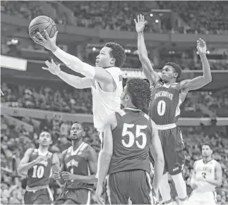  ?? Maddie Meyer / Getty Images ?? Villanova’s Jalen Brunson, center, eludes most of the Mount St. Mary’s Mountainee­rs on his way to the basket during the first half of the Wildcats’ victory in the first round. Brunson had 14 points on 7 of 11 field-goal shooting.