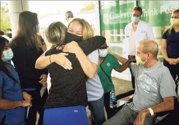  ?? Brian A. Pounds / Hearst Connecticu­t Media ?? Florida residents Susan and Robby Walker hug medical staff Wednesday during Robby’s release from Gaylord Hospital after COVID-19 treatment in Wallingfor­d.