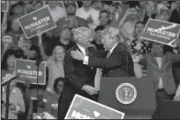  ?? The Associated Press ?? SHOWING SUPPORT: President Donald Trump greets Gov. Henry McMaster during a rally to show support for the governor at Airport High School, Monday in West Columbia, S.C.