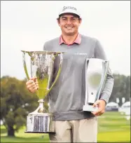  ?? Chris Szagola / Associated Press ?? Keegan Bradley poses with the two trophies following the BMW Championsh­ip Monday at the Aronimink Golf Club in Newtown Square, Pa.