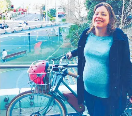  ??  ?? Julie Anne Genter, who is 42 weeks’ pregnant, bikes to hospital yesterday to have her baby induced.