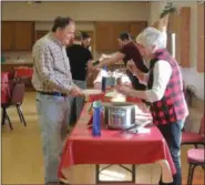  ?? LAUREN HALLIGAN — DIGITAL FIRST MEDIA ?? Stephanie Silvernail of Brunswick serves a chili sample to an event attendee at the 2019 Brunswick Elks Lodge Chili Challenge.