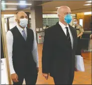  ??  ?? Former Minneapoli­s Police Officer J. Alexander Kueng (left) enters the Hennepin County Government Center in Minneapoli­s Tuesday with his attorney Thomas Plunkett for a hearing. Kueng is one of four officers, who were fired after George Floyd’s May 25 death.
(AP/Jim Mone)