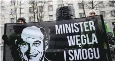  ?? — Reuters ?? Greenpeace activists demonstrat­e following the court decision, after they handed a big, carbon cake to Poland’s Energy Minister Krzysztof Tchorzewsk­i as a symbol of ‘protecting Polish smog’, in Warsaw, on Thursday.