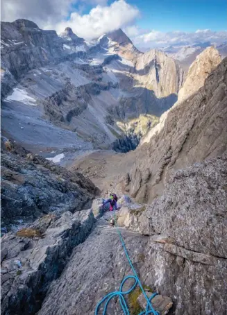  ??  ?? Une des premières longueurs après la brèche Passet. Au fond, la muraille nord de la Tour, le Casque et le Taillon dans les nuages.