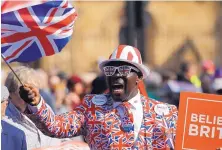  ?? FRANK AUGSTEIN/ ASSOCIATED PRESS ?? A Brexit supporter waves a Union Jack at Parliament Square in Westminste­r, London, on Friday. The U.K. is facing the stark prospect of a chaotic departure from the European Union in just two weeks.