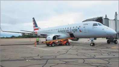  ?? AvPORTS / Contribute­d photo ?? An American Eagle Embraer E175 regional jet, just arrived from Philadelph­ia, is parked on the tarmac at Tweed New Haven Regional Airport in September.